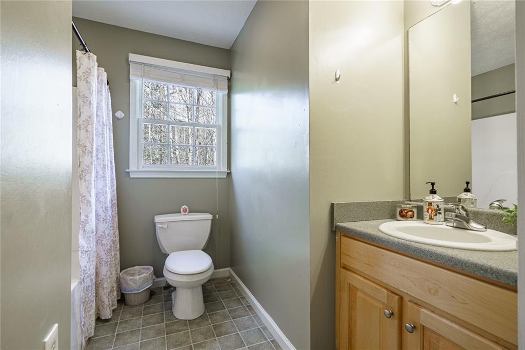 450 High Ridge Lane Dahlonega, GA 30533 - Photo 22 of 39 a bathroom with a toilet sink and a mirror