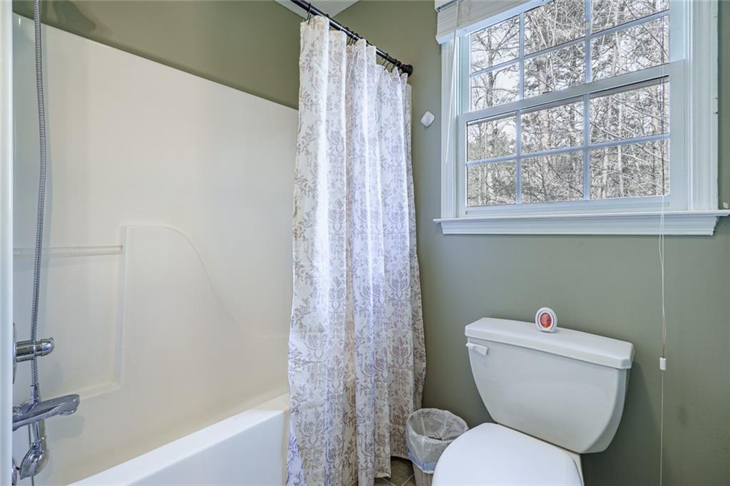 450 High Ridge Lane Dahlonega, GA 30533 - Photo 24 of 39 a white toilet sitting next to a bath tub