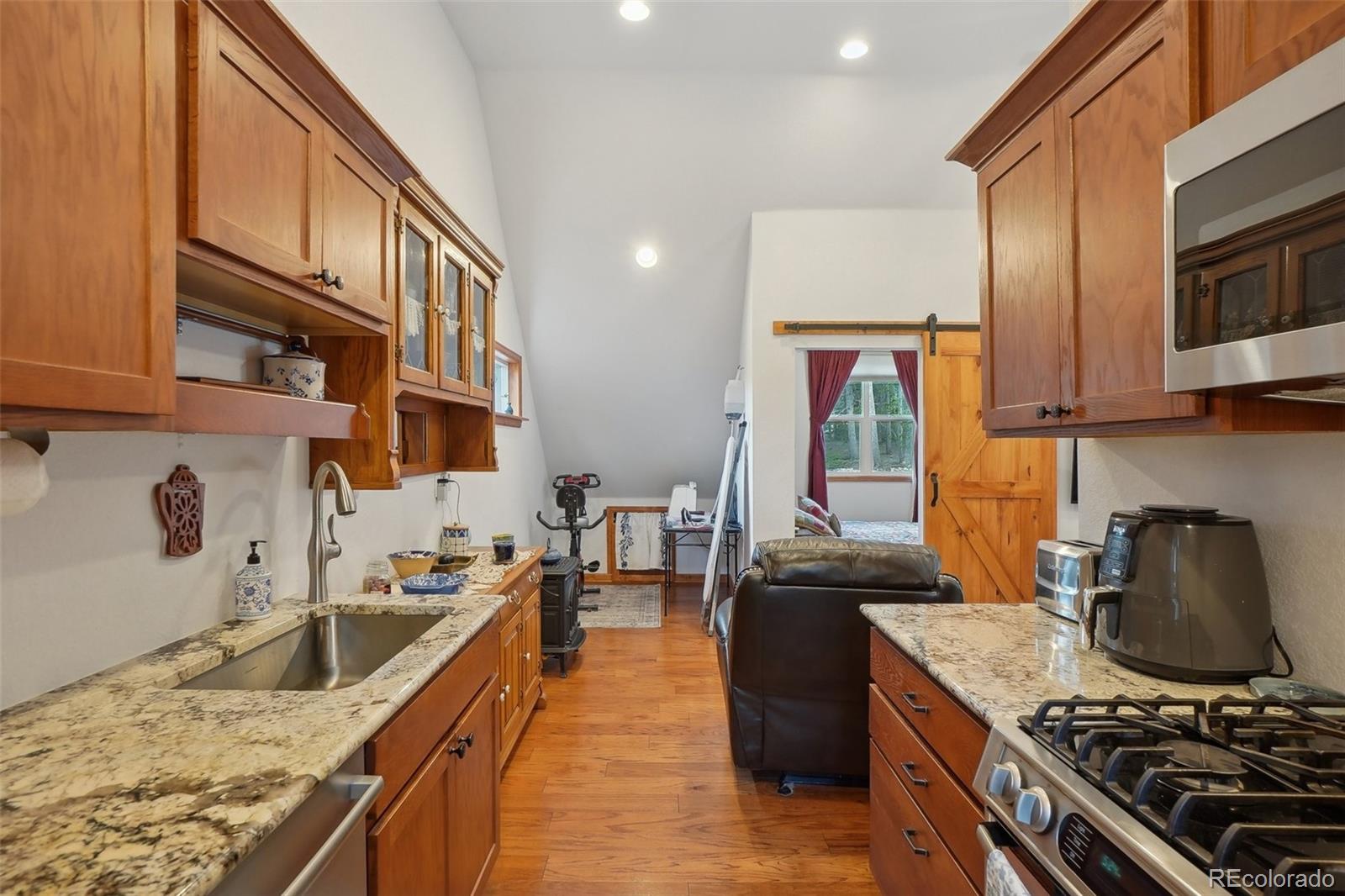 125 Aspen Road Black Hawk, CO 80422 - Photo 26 of 44 a kitchen with stainless steel appliances granite countertop a stove and a sink