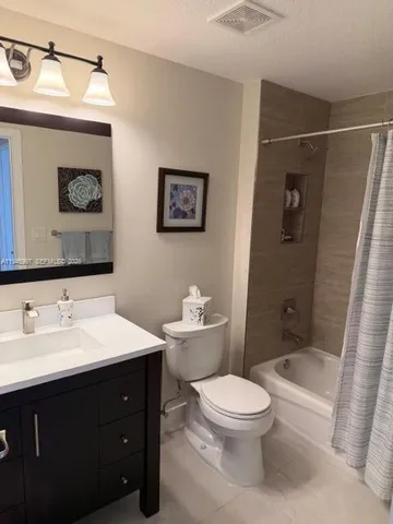 a bathroom with a toilet a sink and shower