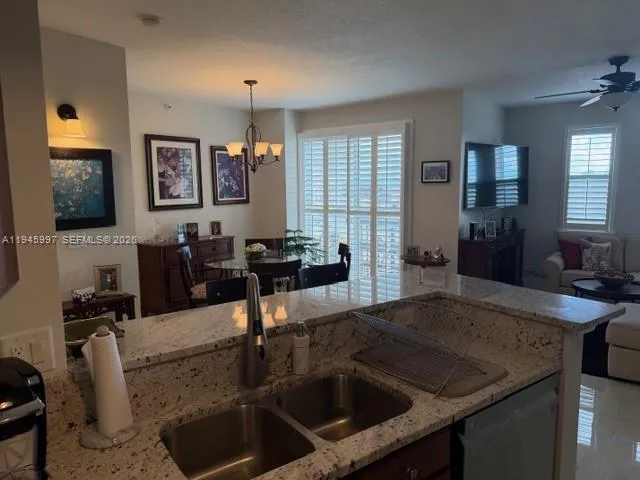 a kitchen with a sink a counter space and dining table