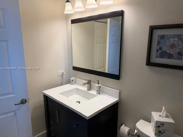 a bathroom with a sink vanity and a mirror