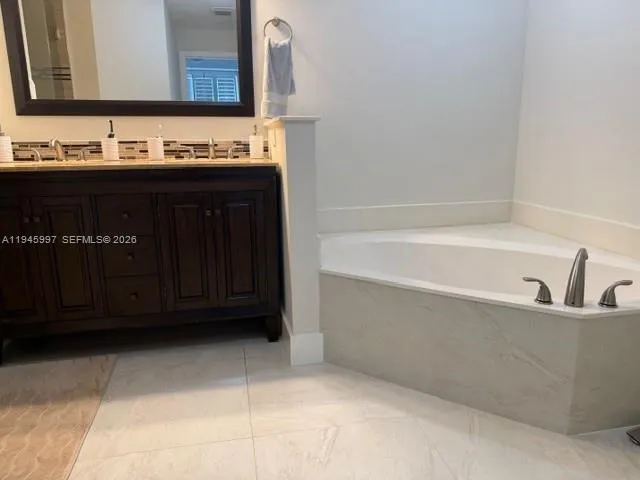 a bathroom with a bathtub and a sink
