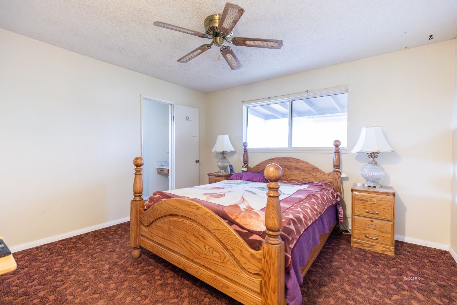 930 West Vulcan Avenue Ridgecrest, CA 93555 - Photo 8 of 19 a bedroom with a bed and a chandelier
