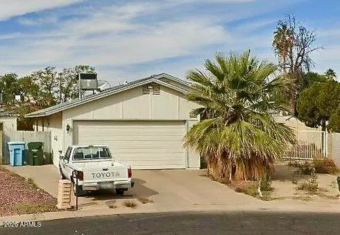 a couple of cars parked in front of a house