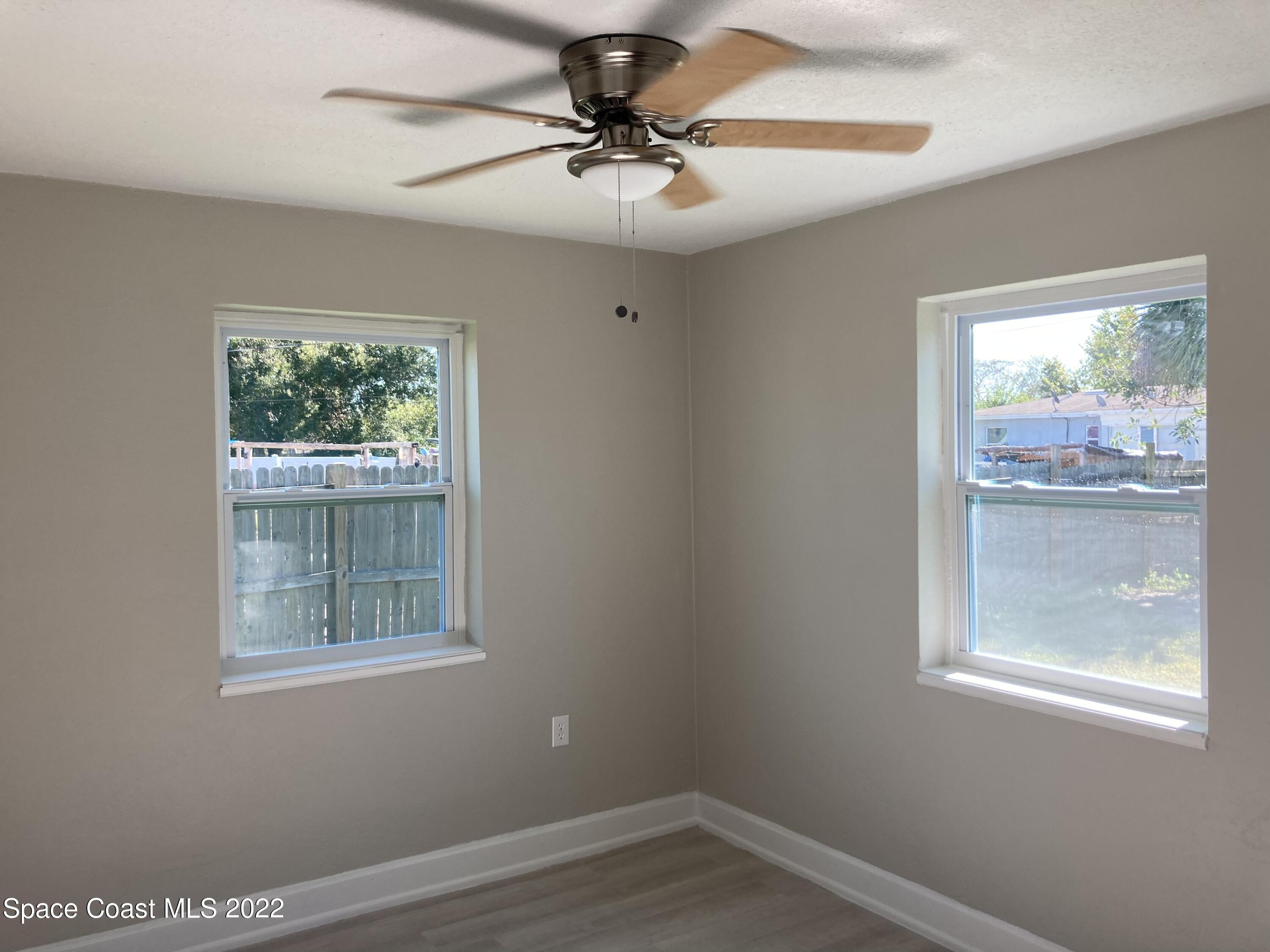 1051 Mitchell Street Cocoa, FL 32922 - Photo 11 of 21 a view of empty room with window and ceiling fan