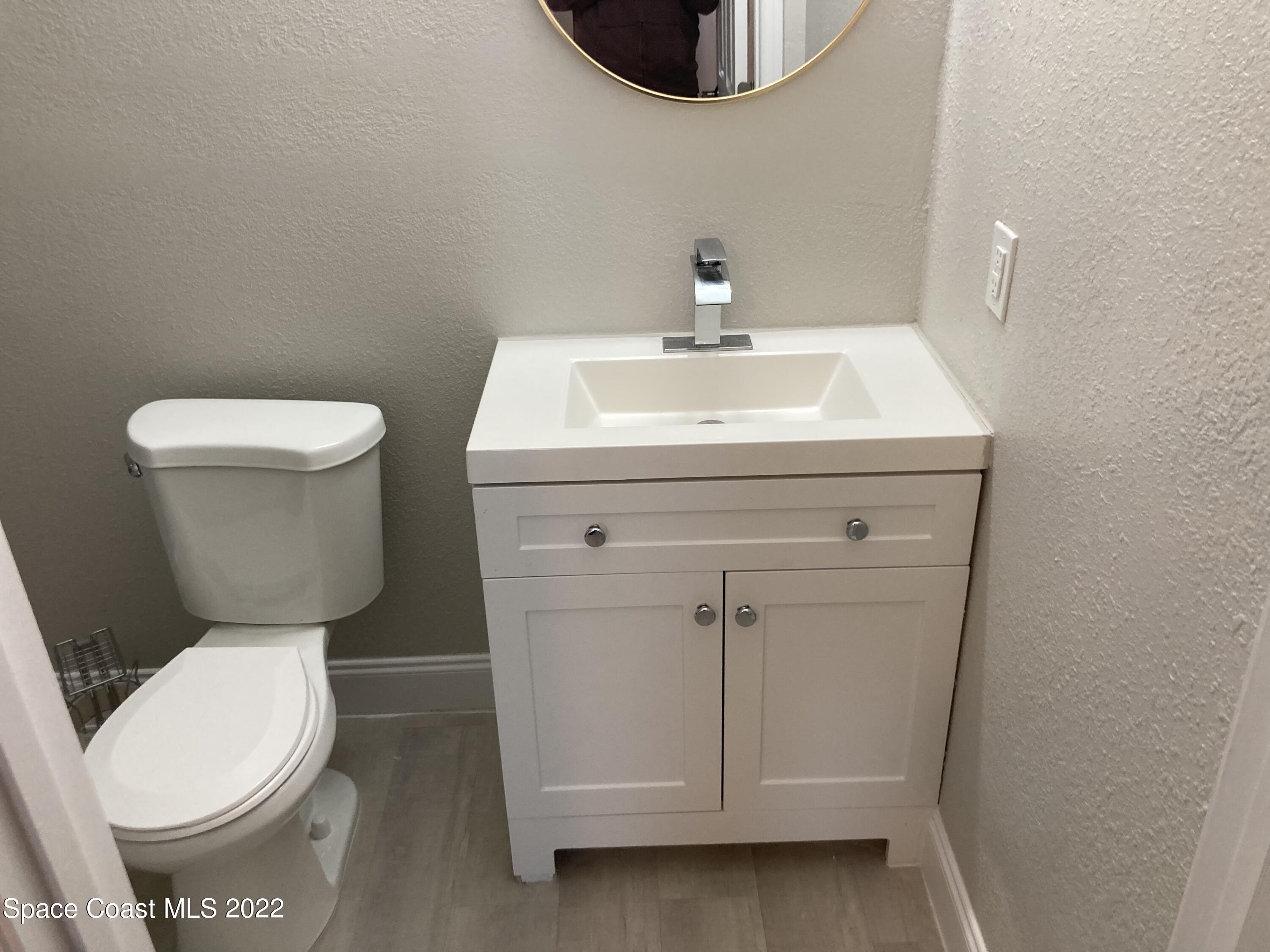 1051 Mitchell Street Cocoa, FL 32922 - Photo 14 of 21 a white toilet sitting next to a sink