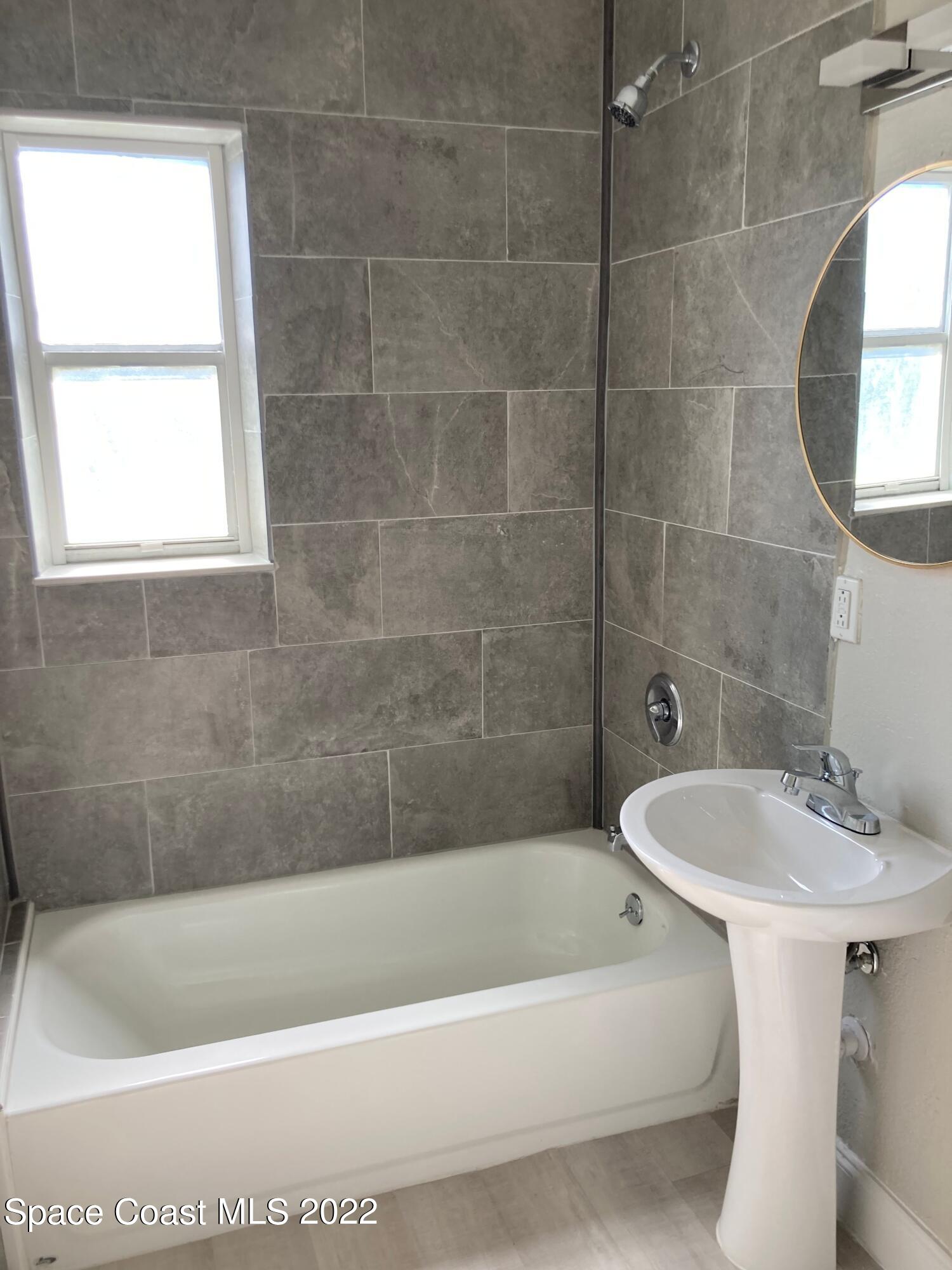 1051 Mitchell Street Cocoa, FL 32922 - Photo 15 of 21 a bath tub sitting next to a white sink