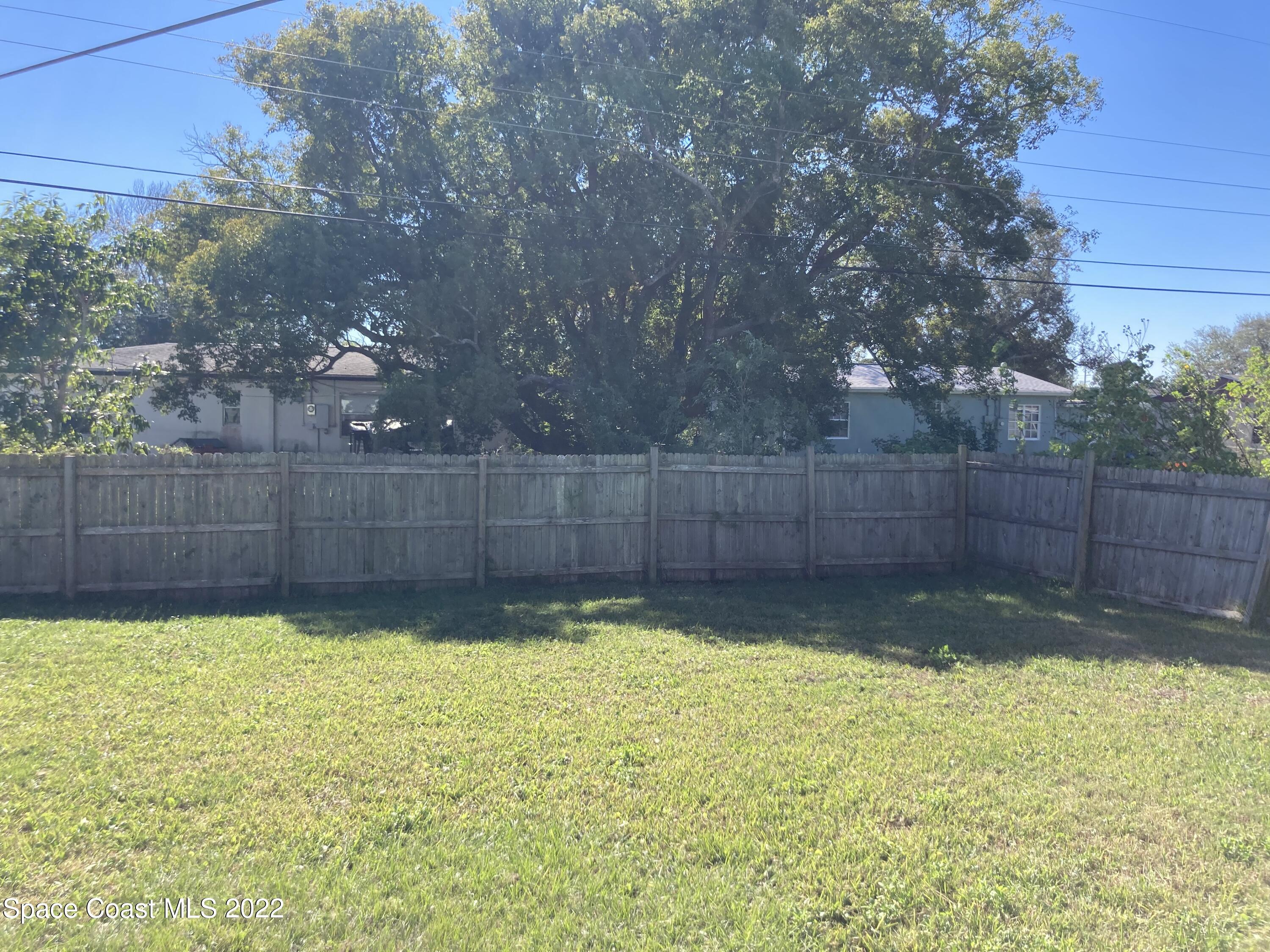 1051 Mitchell Street Cocoa, FL 32922 - Photo 19 of 21 a view of a backyard with a small cabin
