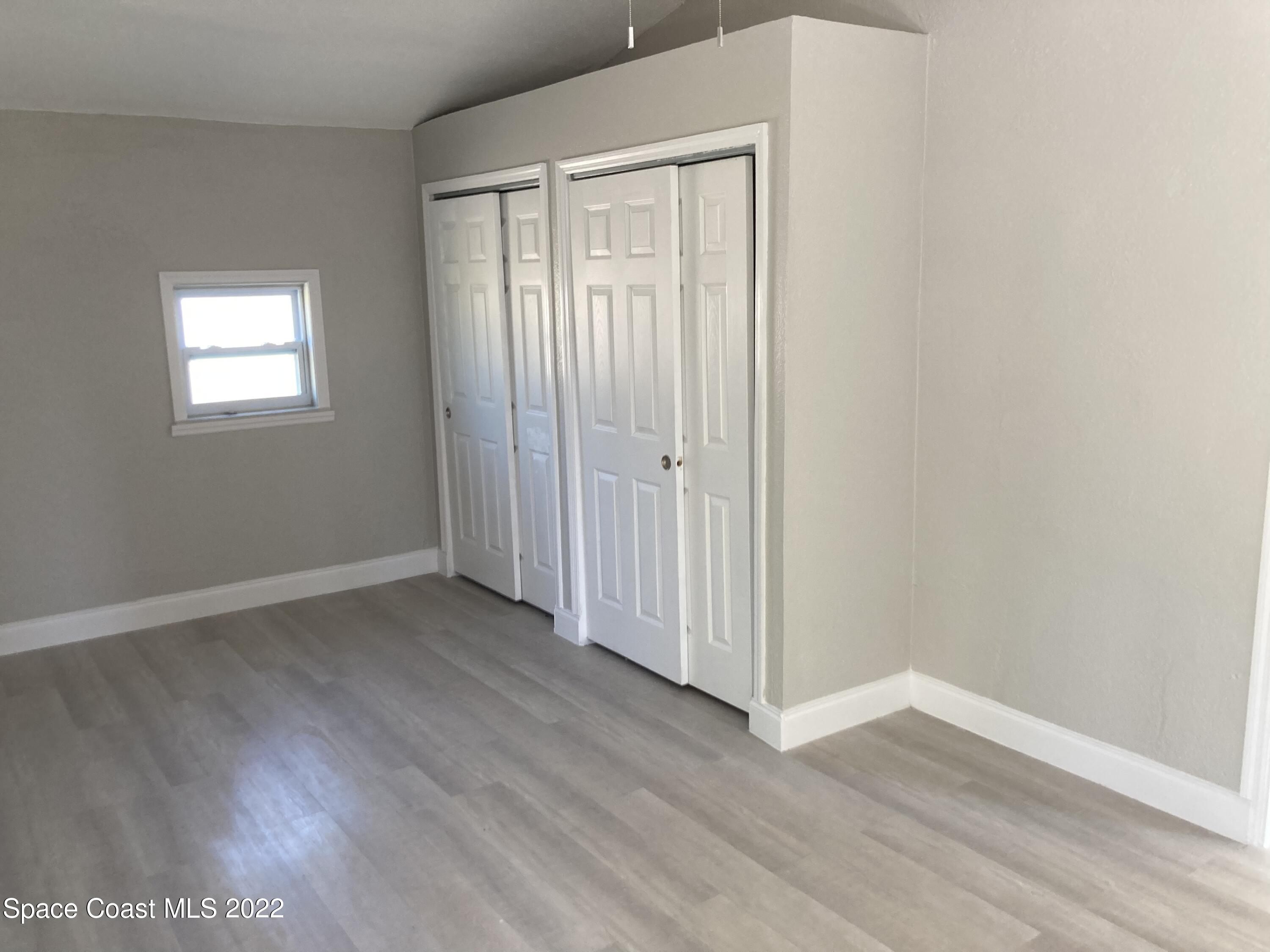 1051 Mitchell Street Cocoa, FL 32922 - Photo 8 of 21 a view of a livingroom with wooden floor