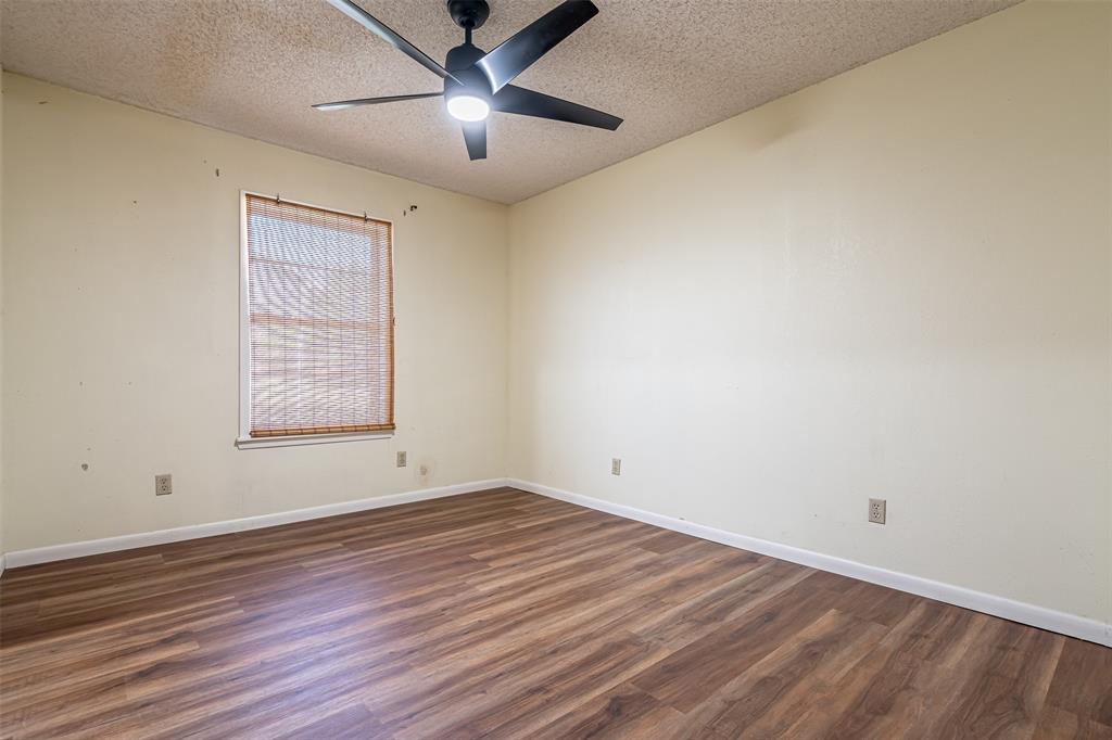 501 Endora Dublin, TX 76446 - Photo 30 of 39 wooden floor in an empty room with a window