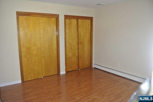 164 Scoles Avenue, Unit 2 Clifton, NJ 07012 - Photo 16 of 16 an empty room with wooden floor and closet area