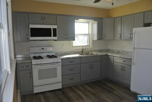 a kitchen with a sink stove and microwave