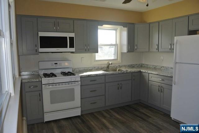 164 Scoles Avenue, Unit 2 Clifton, NJ 07012 - Photo 6 of 16 a kitchen with a sink stove and microwave
