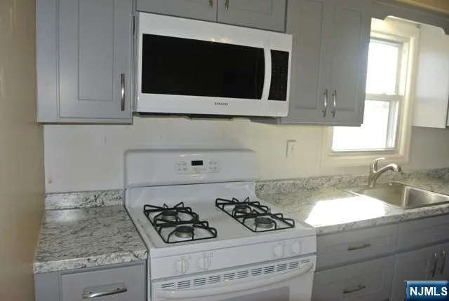 a kitchen with a stove and a microwave