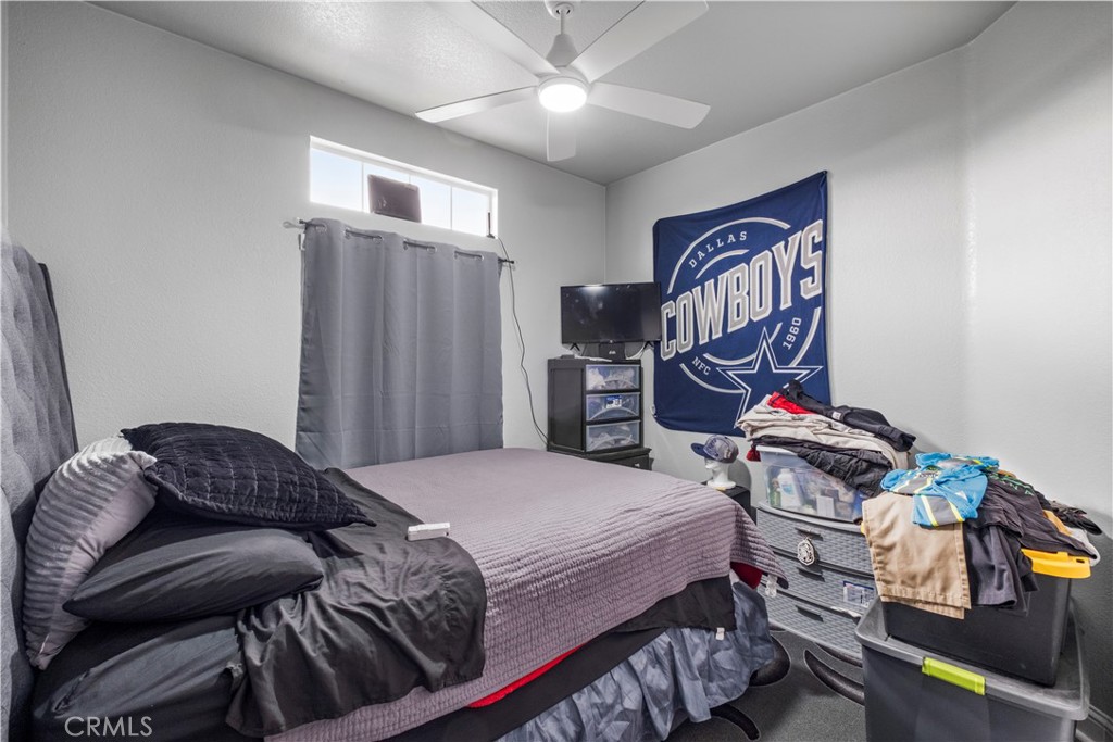 2139 East 4th Street, Unit 84 Ontario, CA 91764 - Photo 14 of 25 a bedroom with a bed and wooden floor
