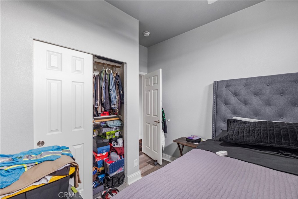 2139 East 4th Street, Unit 84 Ontario, CA 91764 - Photo 16 of 25 a bedroom with a bed and a dresser