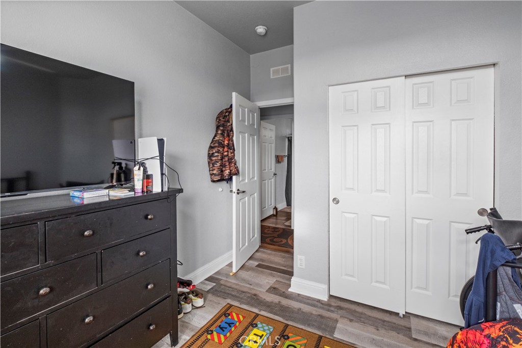 2139 East 4th Street, Unit 84 Ontario, CA 91764 - Photo 17 of 25 a room with cabinets and wooden floor