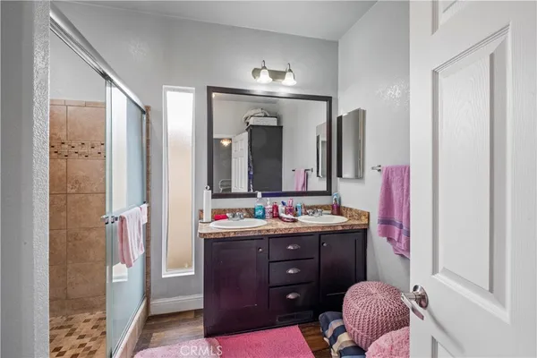 a bathroom with a sink vanity mirror and shower