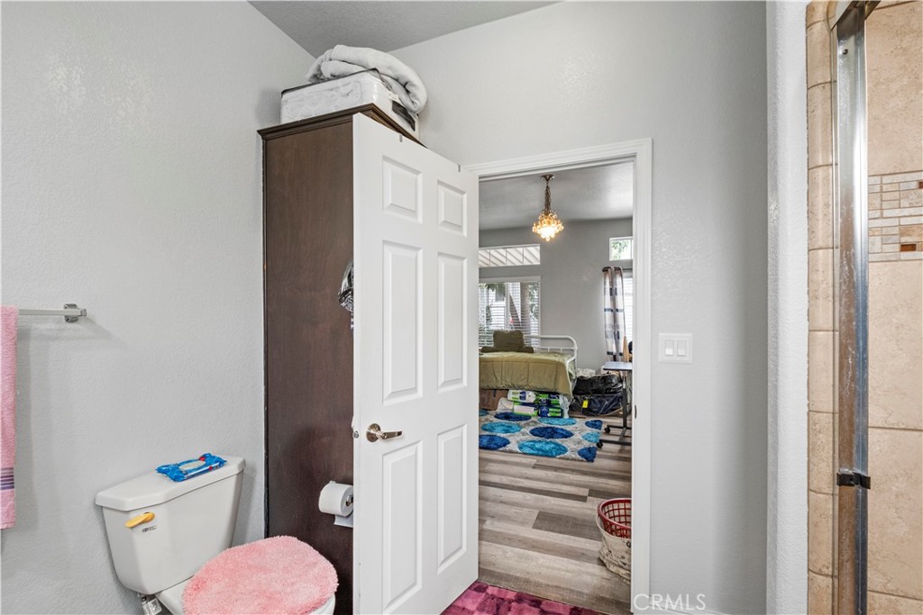 2139 East 4th Street, Unit 84 Ontario, CA 91764 - Photo 21 of 25 a view of a hallway to a livingroom and a dining room with furniture