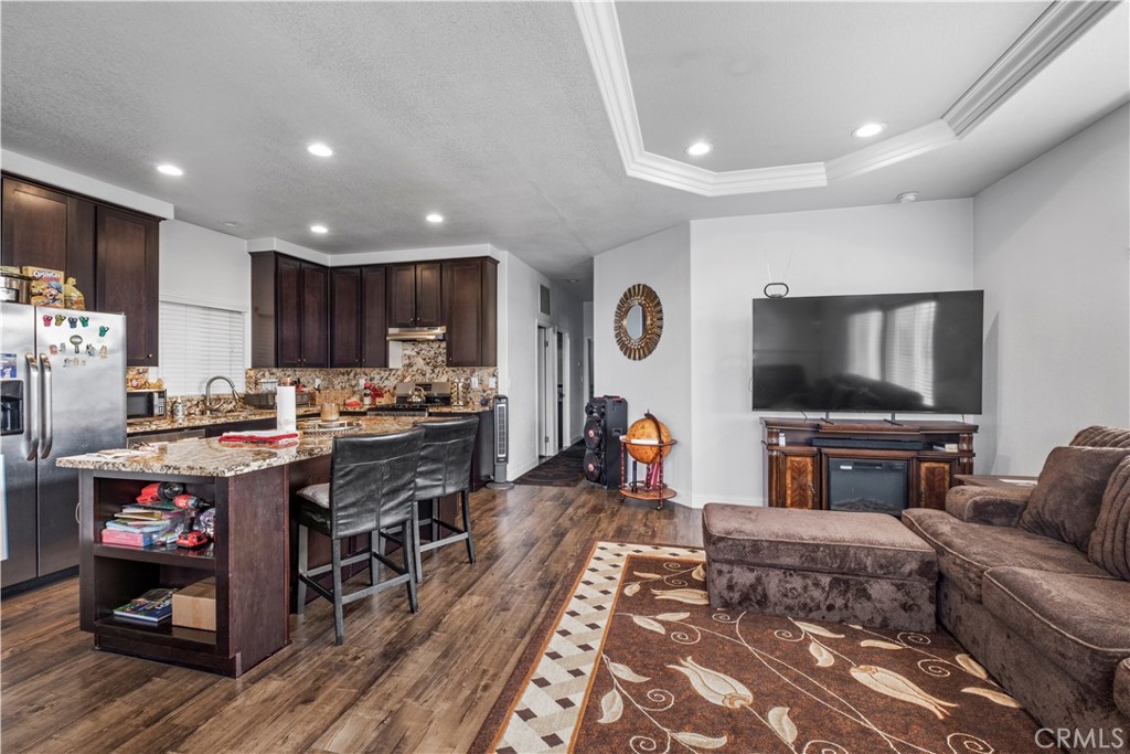 2139 East 4th Street, Unit 84 Ontario, CA 91764 - Photo 6 of 25 a living room with furniture and a flat screen tv