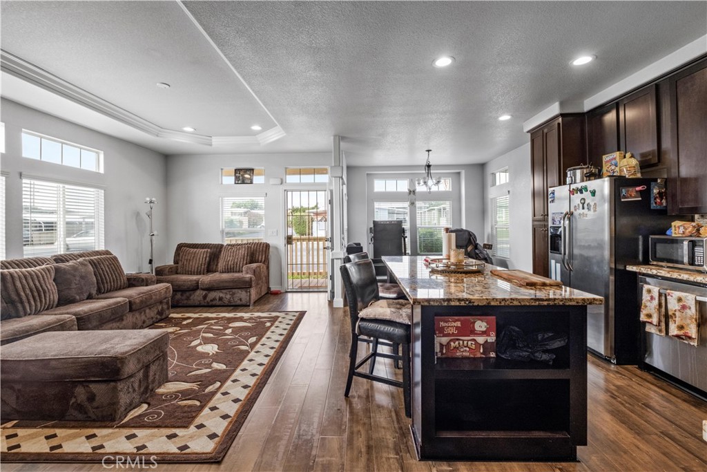 2139 East 4th Street, Unit 84 Ontario, CA 91764 - Photo 7 of 25 a living room with furniture and a wooden floor
