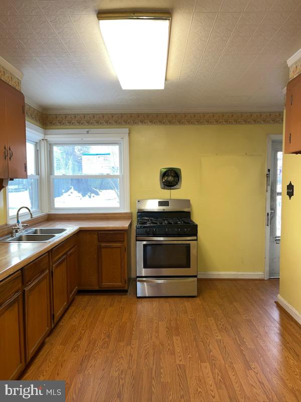 23 Kingsley Road Owings Mills, MD 21117 - Photo 2 of 9 a kitchen with stainless steel appliances a stove a sink and wooden floor