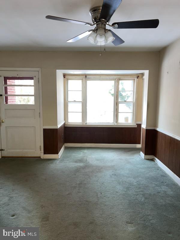 23 Kingsley Road Owings Mills, MD 21117 - Photo 4 of 9 an empty room with chandelier fan and windows