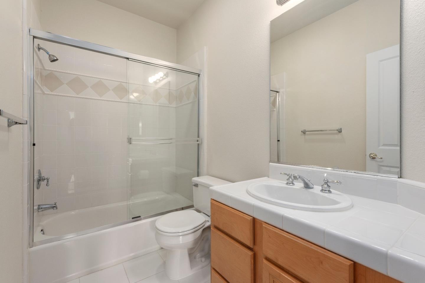 72 Cannery Circle Campbell, CA 95008 - Photo 15 of 20 a bathroom with a granite countertop sink a toilet and shower