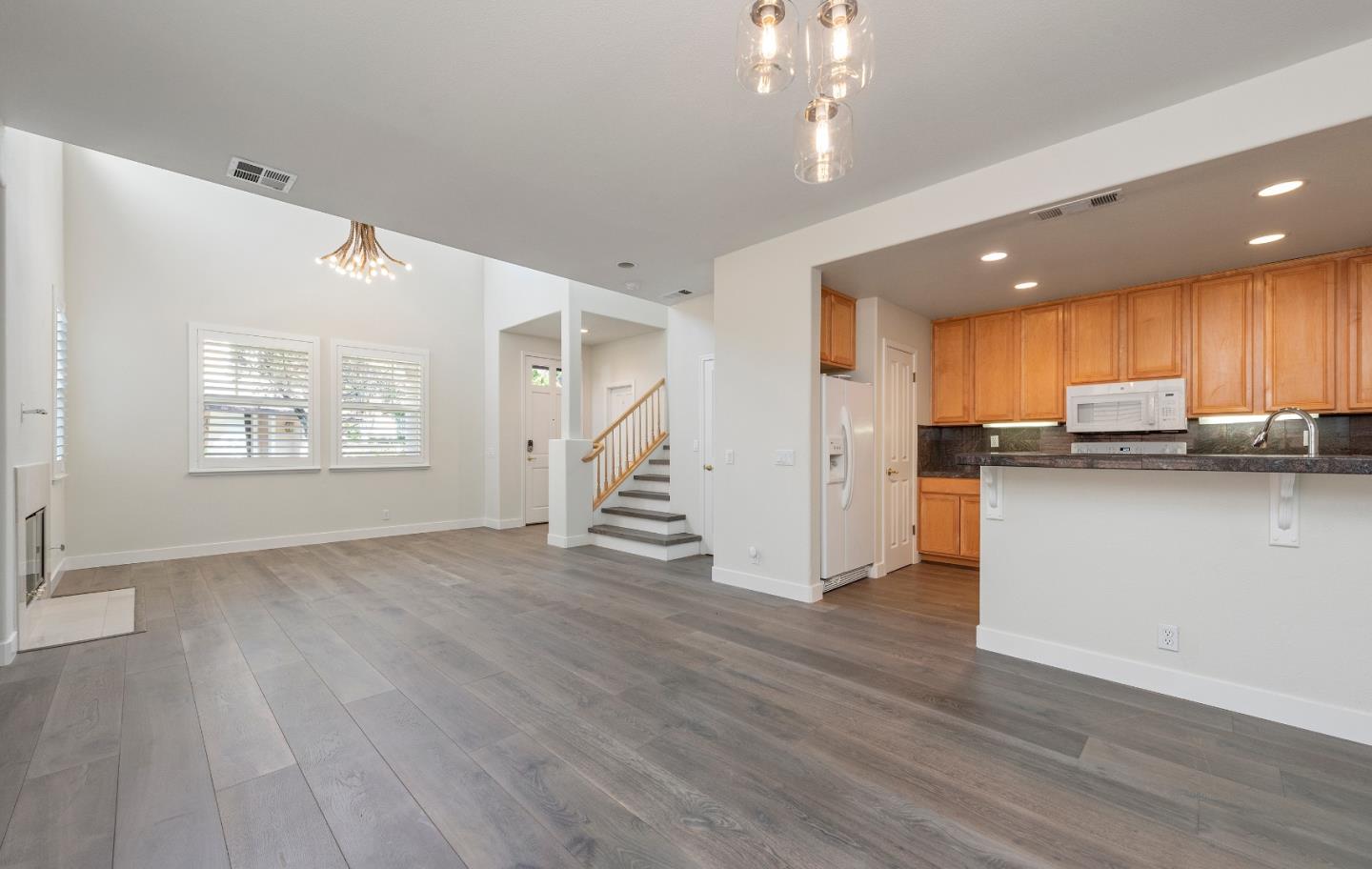 72 Cannery Circle Campbell, CA 95008 - Photo 3 of 20 a view of kitchen with refrigerator stove and wooden floor