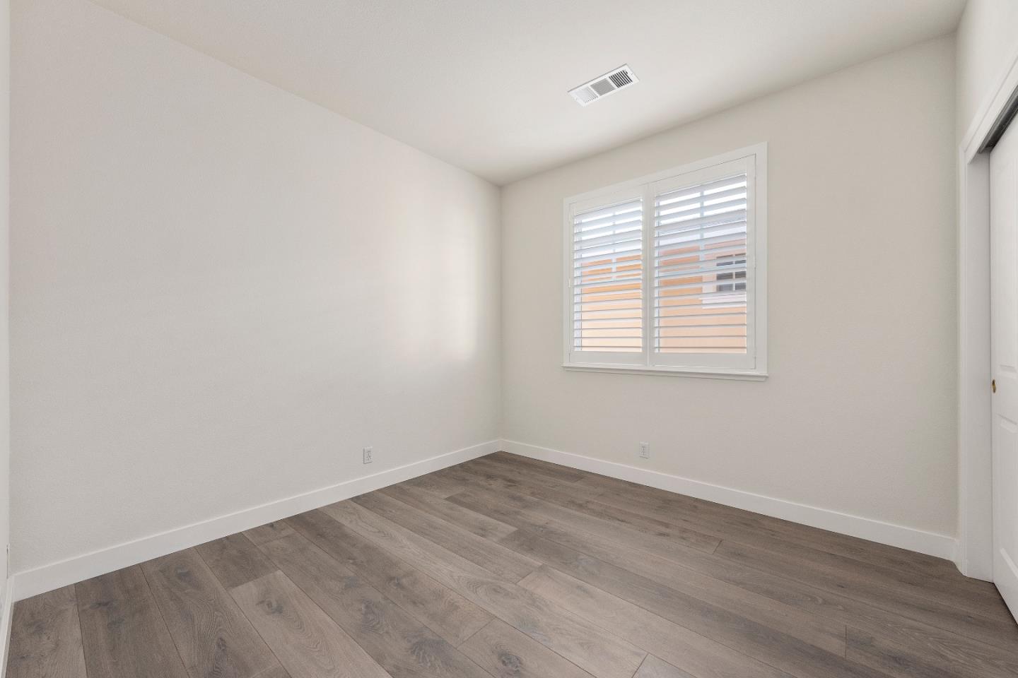 72 Cannery Circle Campbell, CA 95008 - Photo 7 of 20 an empty room with wooden floor and windows