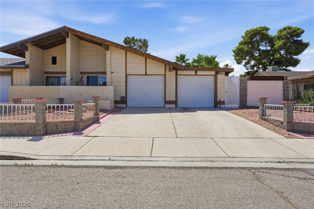 3971 Spring Leaf Drive Las Vegas, NV 89147 - Photo 6 of 48 A well-maintained concrete driveway leads to the attached double garages of this home.