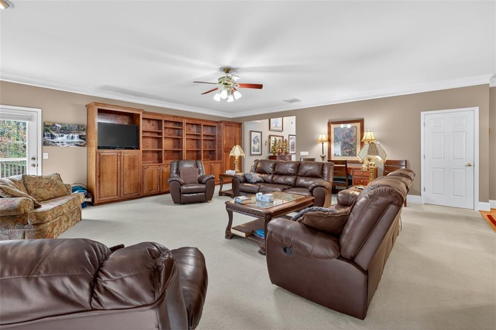 3357 Rising Fawn Trail Suwanee, GA 30024 - Photo 12 of 93 a living room with furniture a ceiling fan and a window