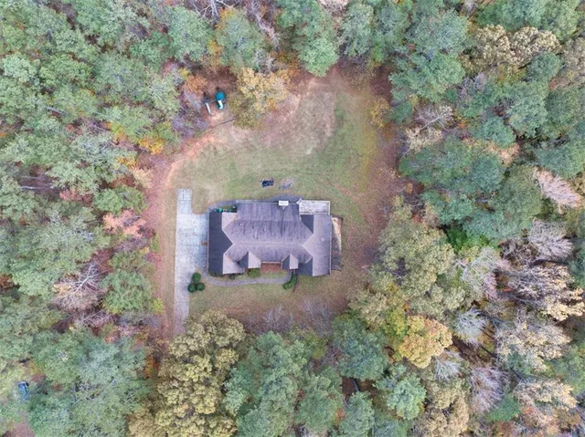 an aerial view of a house with a yard