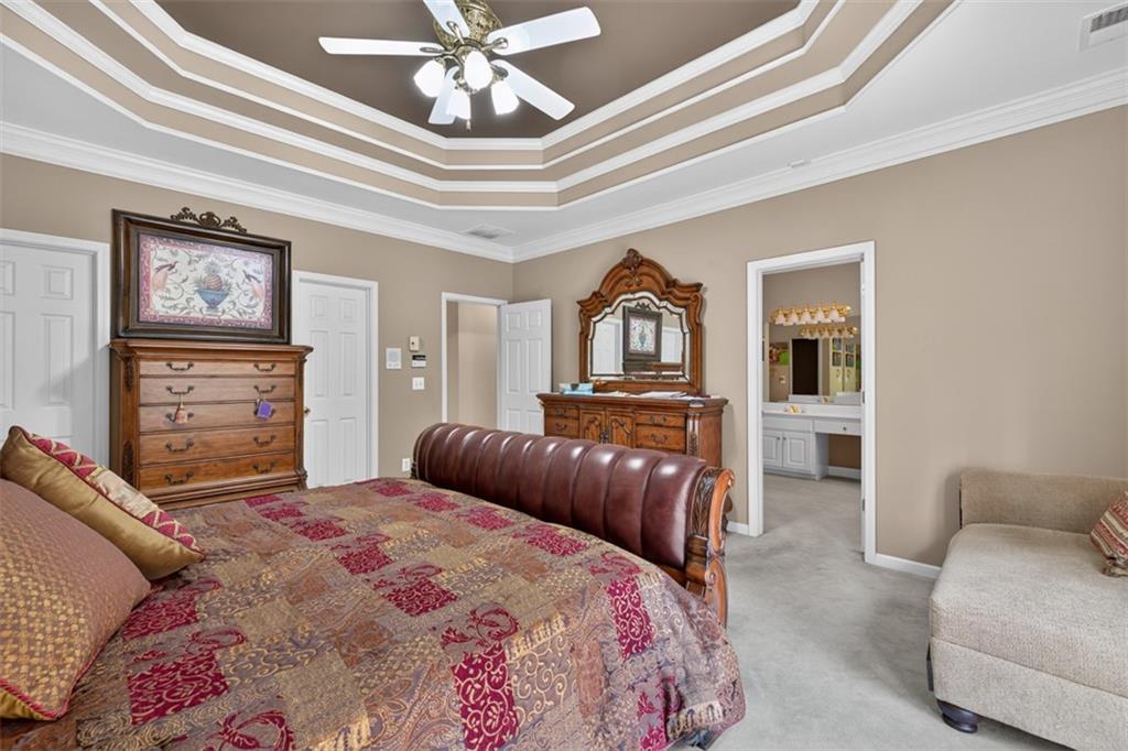 3357 Rising Fawn Trail Suwanee, GA 30024 - Photo 22 of 93 a bedroom with a bed furniture and a chandelier