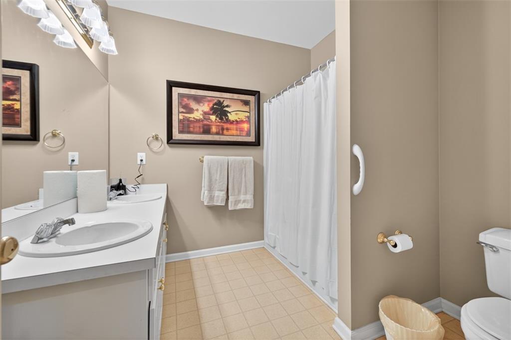 3357 Rising Fawn Trail Suwanee, GA 30024 - Photo 29 of 93 a bathroom with a sink a toilet and shower