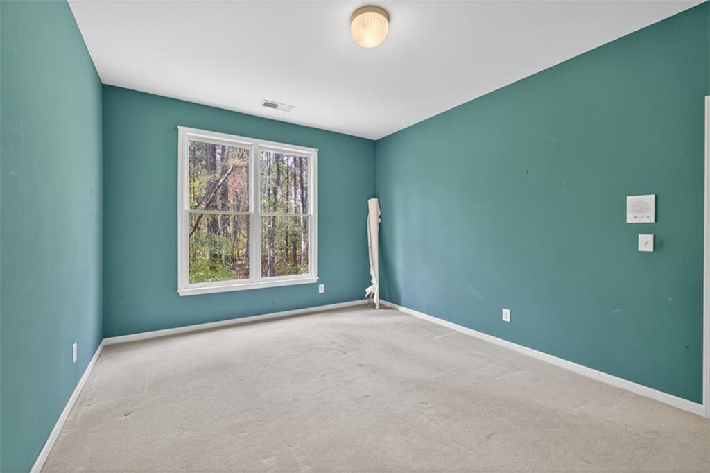 3357 Rising Fawn Trail Suwanee, GA 30024 - Photo 31 of 93 a view of a livingroom with an empty space and window