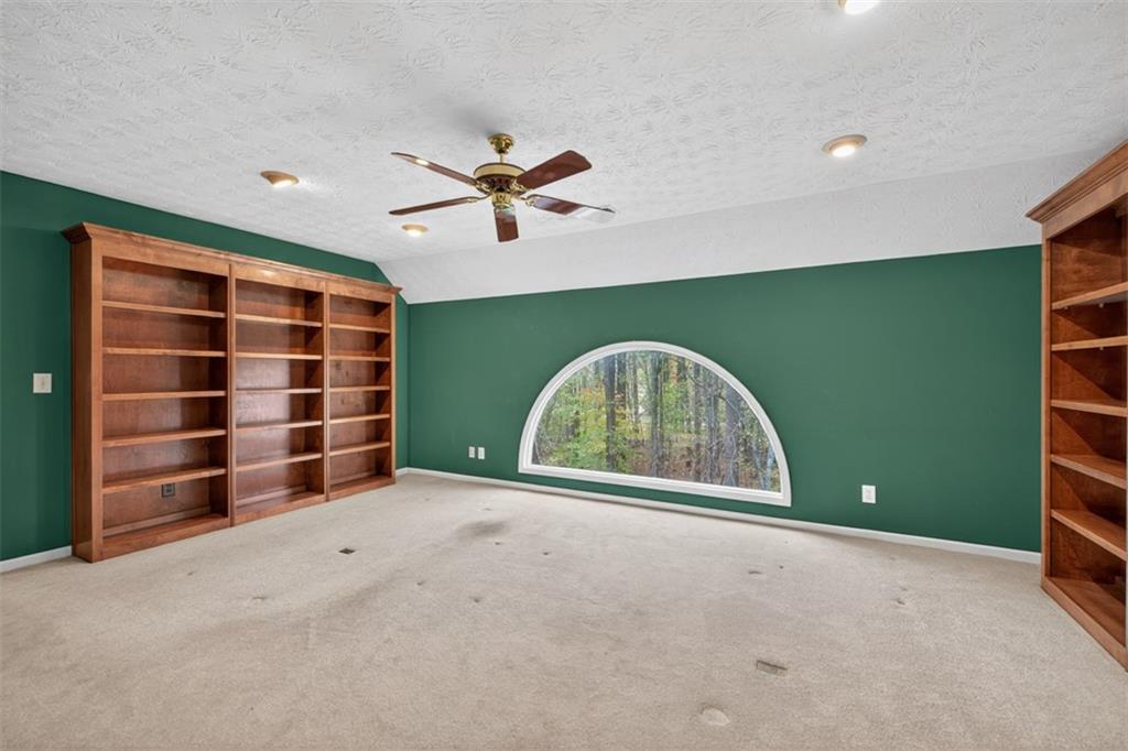 3357 Rising Fawn Trail Suwanee, GA 30024 - Photo 35 of 93 a view of an empty room with a fireplace and a large window