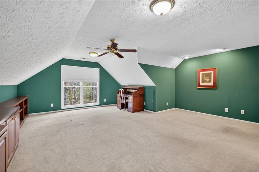3357 Rising Fawn Trail Suwanee, GA 30024 - Photo 38 of 93 a view of a livingroom with a ceiling fan and window