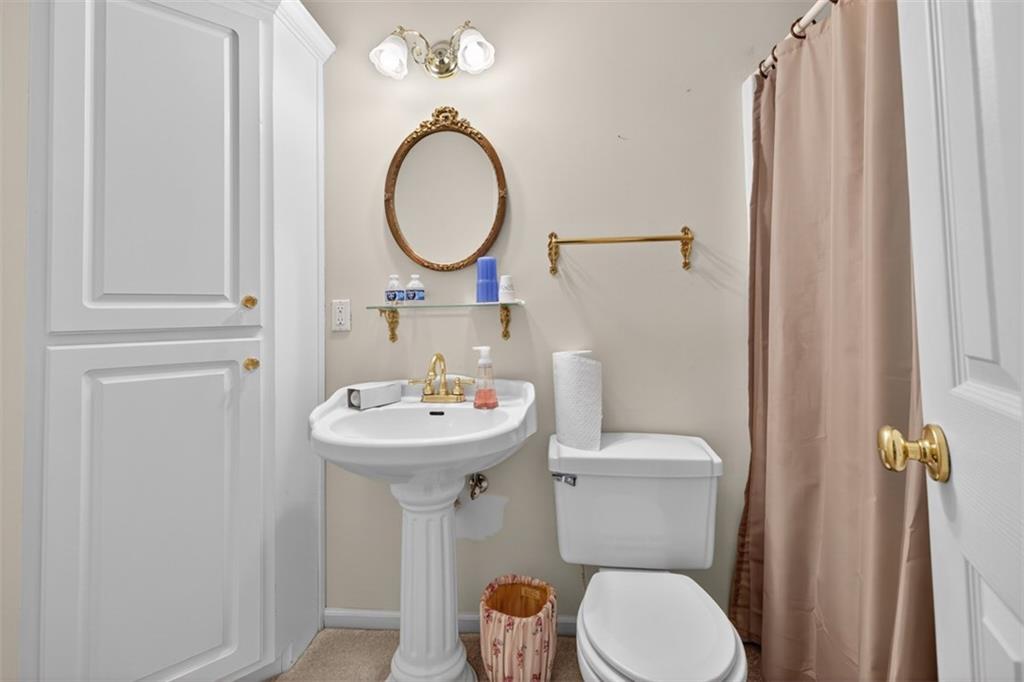 3357 Rising Fawn Trail Suwanee, GA 30024 - Photo 44 of 93 a bathroom with a toilet sink and mirror