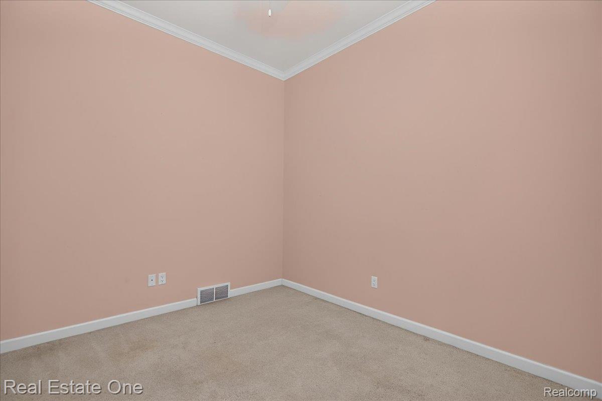 425 Courtney Road Leonard, MI 48367 - Photo 37 of 89 Room featuring carpet flooring, painted walls, white baseboards, and white crown molding