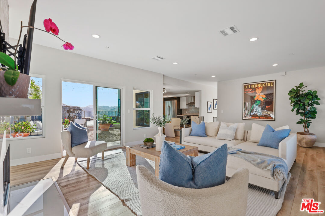 53 Saddlebow Road Bell Canyon, CA 91307 - Photo 20 of 66 a living room with furniture and a potted plant