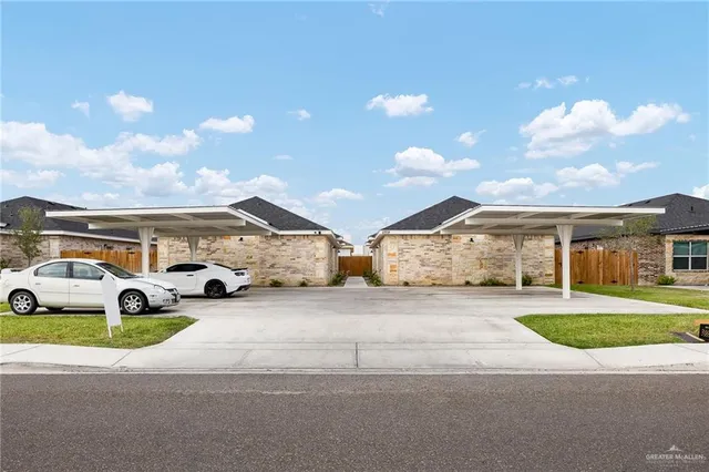 a view of multiple houses with a yard