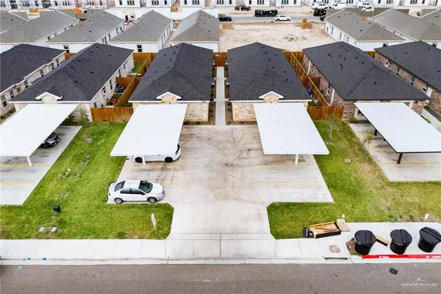 an aerial view of a house with yard garage and a patio