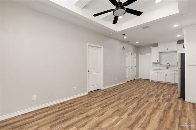 a view of a kitchen with a sink and a refrigerator