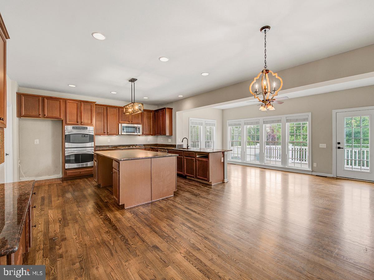540 Morgan Drive Mickleton, NJ 08056 - Photo 13 of 33 a large kitchen with stainless steel appliances granite countertop a stove and a wooden floors