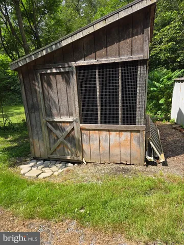a view of a small barn with a large window