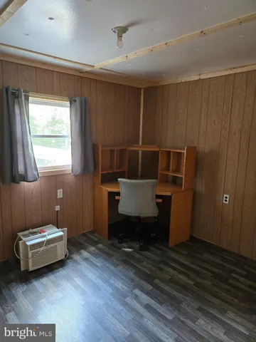 a room with wooden floor and furniture