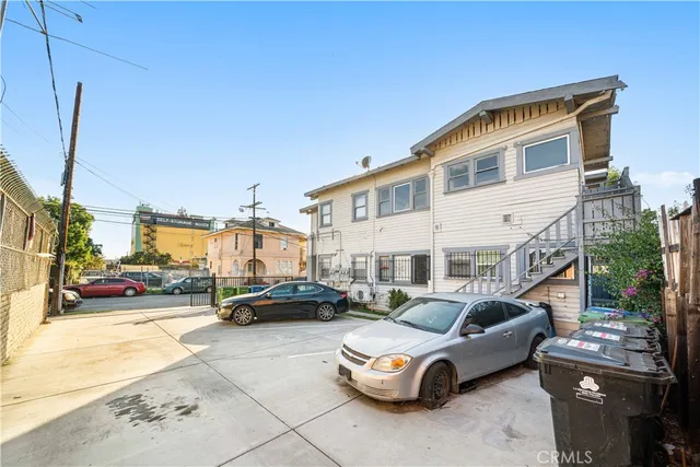a building outdoor space with patio furniture and potted plants