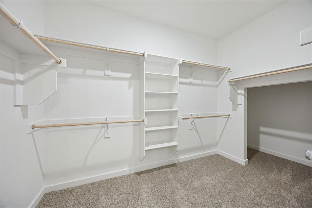 2104 Sunshining Road Princeton, TX 75407 - Photo 23 of 39 Primary Closet in the Stanley II home plan by Trophy Signature Homes – REPRESENTATIVE PHOTO